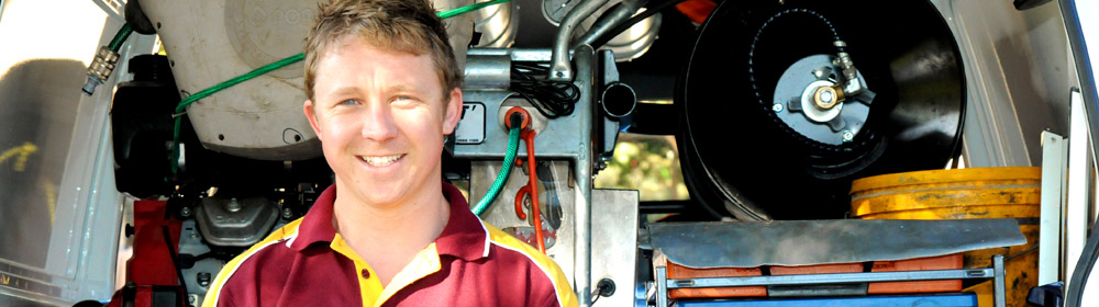 Jake, one of our plumbers in Clinton, standing in the back of his fully stocked truck